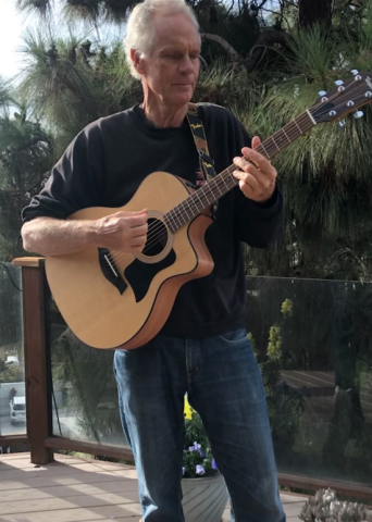 Glenn Vanstrum playing acoustic guitar