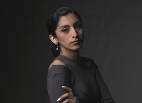 A portrait photograph of a woman with her hair pulled back wearing a grey top by an artist from the San Diego Portrait Club.