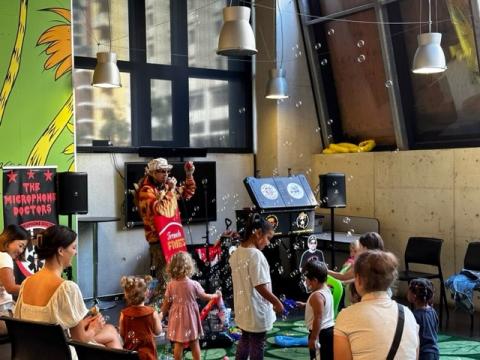 Kids enjoying a costumed dance party with Danny Darko from The Microphone Doctors.