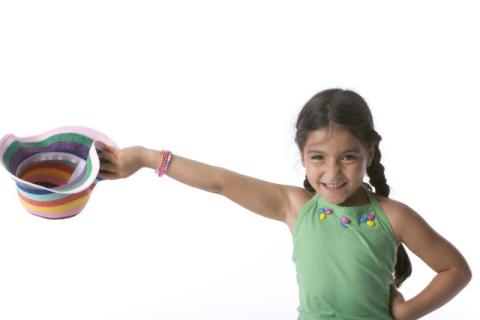 Girl with a hat in hand making a dramatic gesture