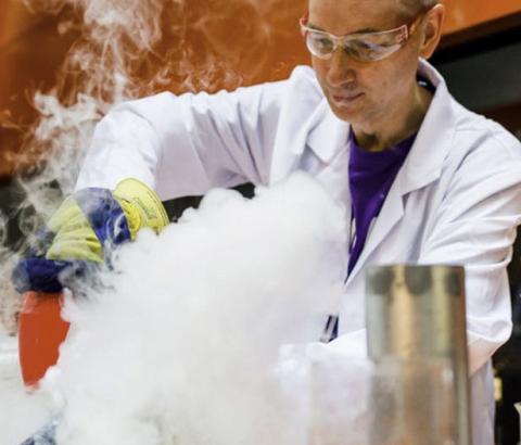 Man in lab coat with steam billowing in front of him