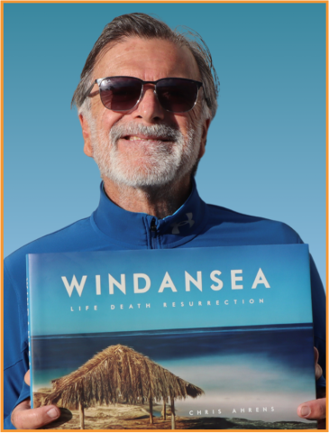 Author Chris Ahrens holding a copy of his book Windansea: Life. Death. Resurrection.