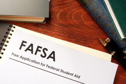 Open notebook with "FAFSA" "Free Application for Federal Student Aid" written at the top of the page