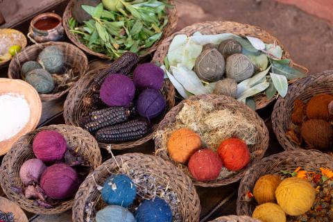 Baskets of multicolored yarn and natural materials used to dye them