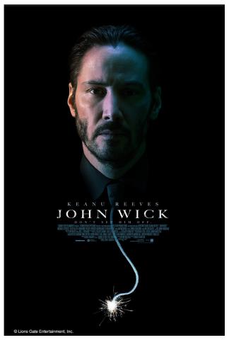 Photograph of a man's face in surrounded by darkness.