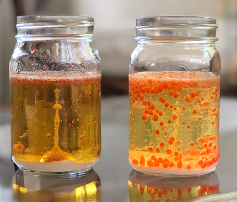 Two lava lamp jars with orange bubbles