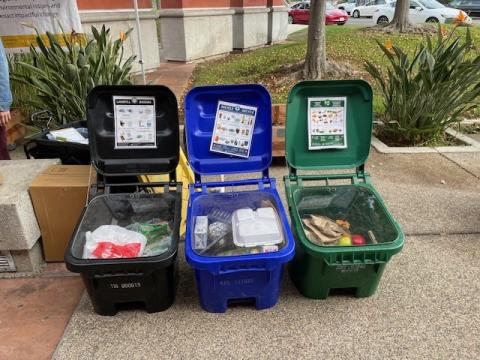 three waste bins with lids open