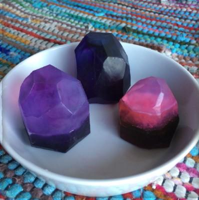 Photo of 3 colorful, gem-shaped soaps in a white dish.  