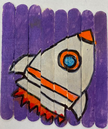 Craft stick puzzle with a picture of a rocket ship on it