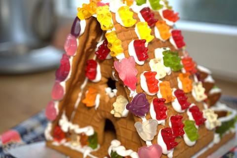 Triangular gingerbread house with gummy candy decoration