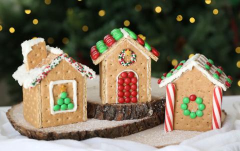 Three gingerbread houses decorated with colorful candies