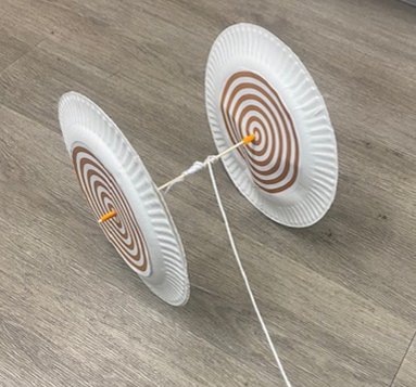 Wheel and axle made out of paper plates and a wooden skewer, with a string wound around the center of the axle