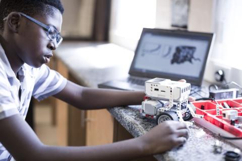 boy working on small robot