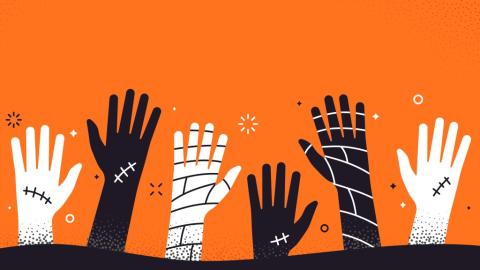 black and white zombie hands coming out of ground against orange background