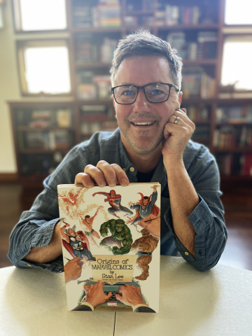 Author Chris Ryall smiles and presents his latest comic book. 