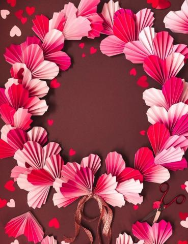 A decorative wreath composed of pink & white paper hearts.
