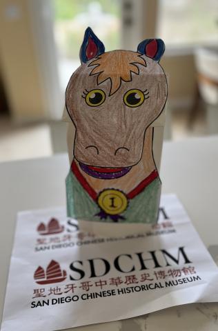 A horse puppet on a paper bag.