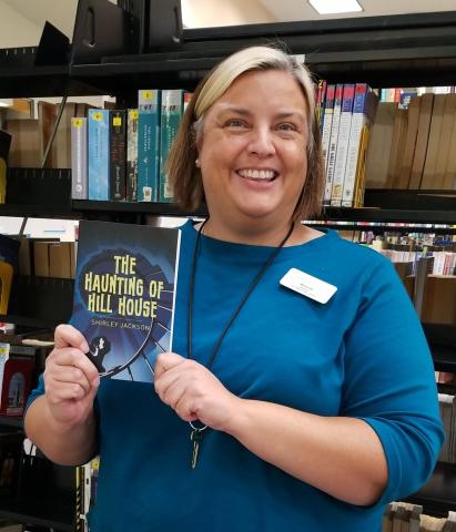 picture of Maureen, the librarian, holding a book