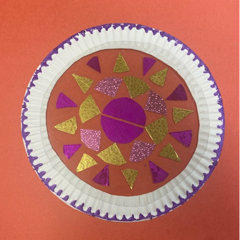 Paper semicircles and other circle fractions forming a pattern inside a paper plate border