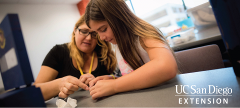 Girls Looking Closely at Table