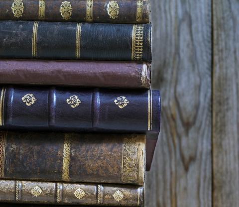 A stack of old books with character