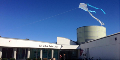 A kite flying above the PB Library