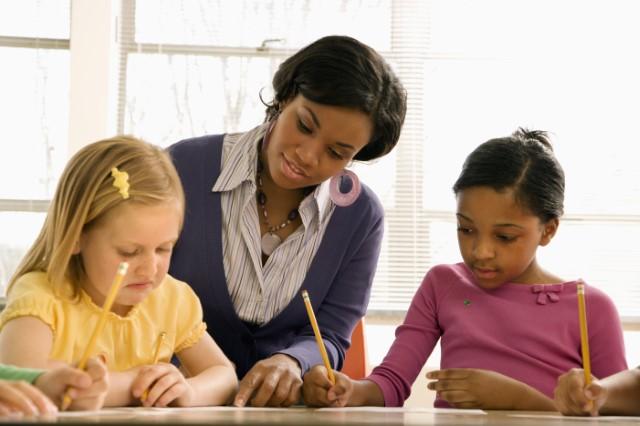 teacher helping students