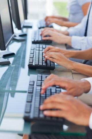 hands typing on computer keyboard