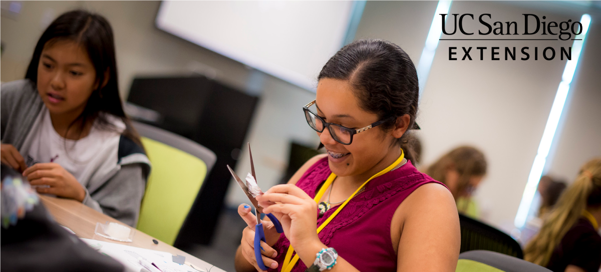 Photo of girl using scissors.