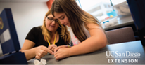 students inspecting slimy sea creature 