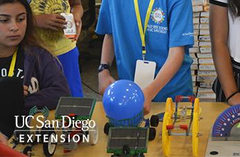 Children working with electronics and balloon.