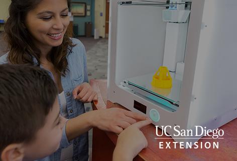 Child and woman pressing a button on a 3d printer