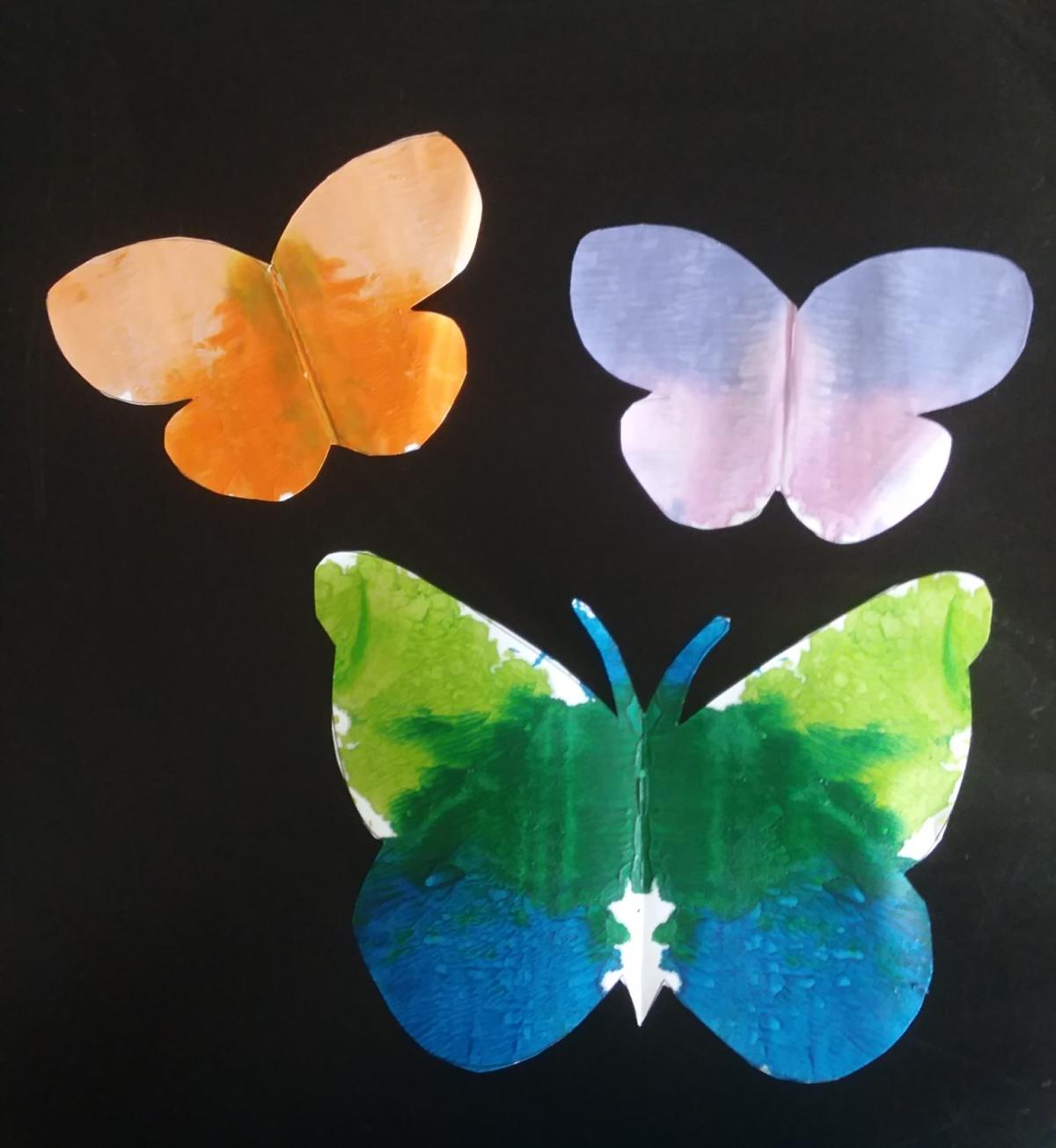 Three Multi-colored paper butterflies