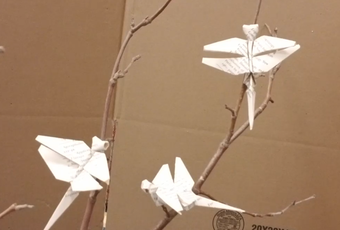 Paper dragonflies on tree branch