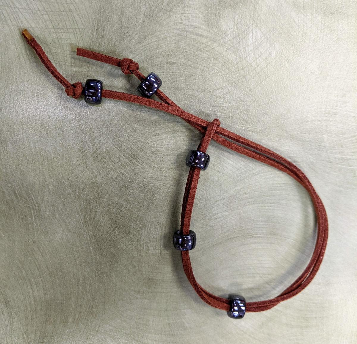 Brown faux suede bracelet with shiny grey beads