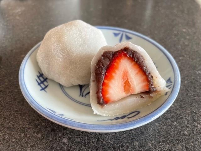 Plate with a strawberry wrapped in sweet bean paste and rice cake