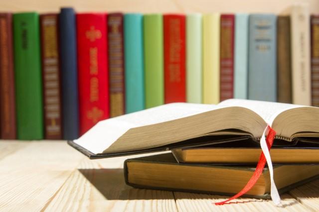 a row of books, with one open book