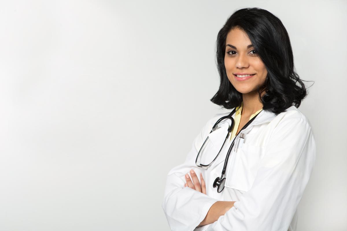 female in lab coat with stethoscope around her neck