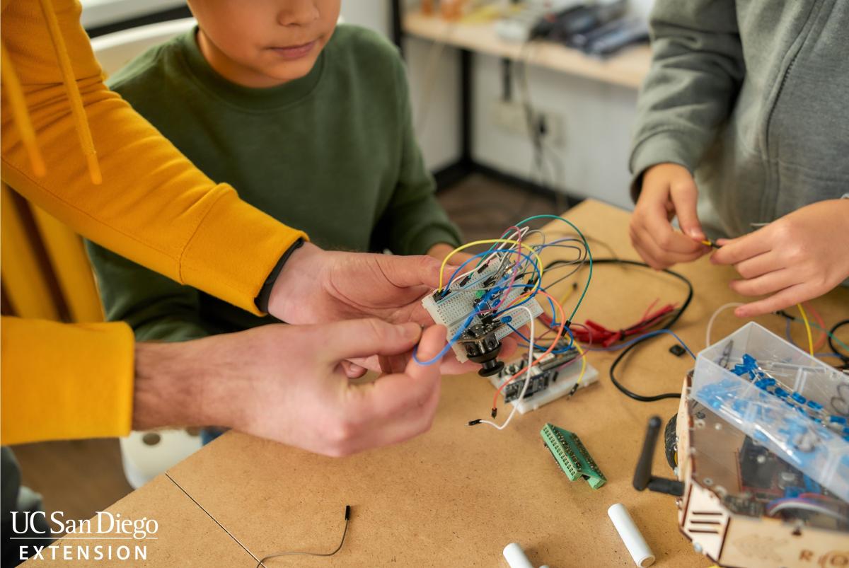 Students working on circuits project with teacher