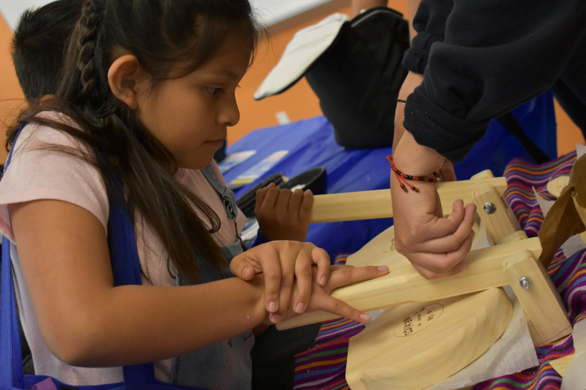 Girl with a tortilla press.