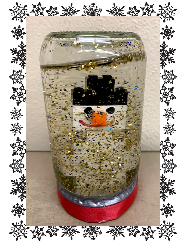 Glass jar snow globe with Lego snowman inside