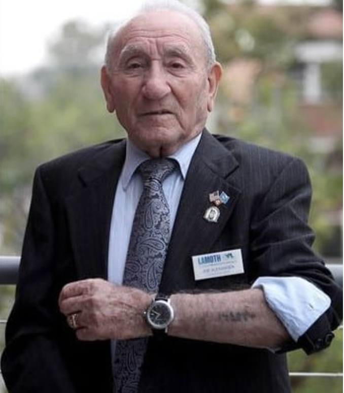 A photo of Joseph Alexander, an elderly man wearing a suit.