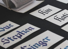 Photograph of hand-lettered name tags by artists from the San Diego Society for Calligraphers. 