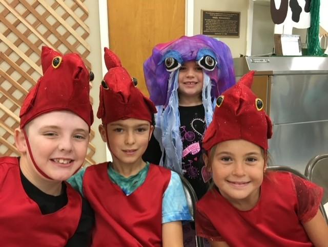 Children in fish costumes