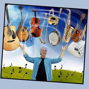 Picture of Craig Newton in the fore ground with musical instruments above his head with a blue sky & green hill background.