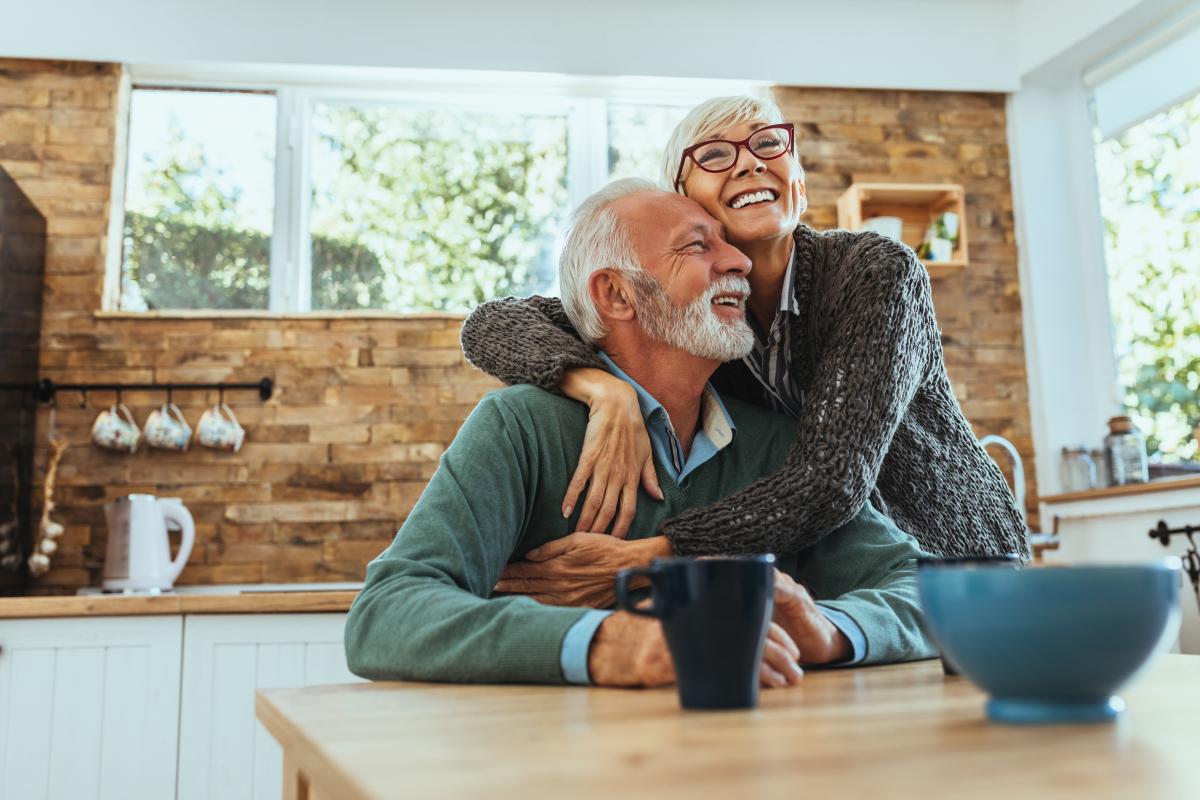 Older Couple Embracing in Kitchen