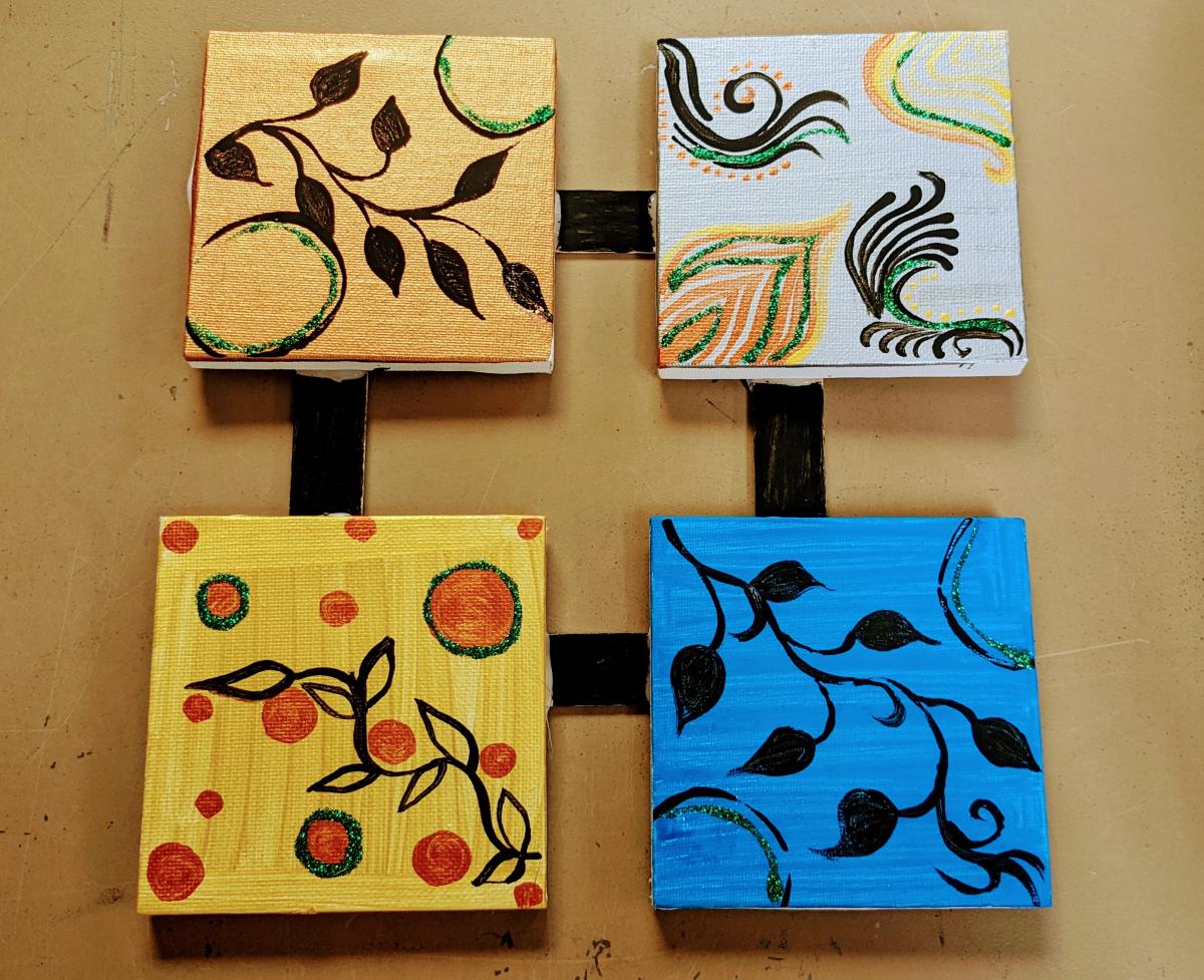 Four connected mini canvas frames that are painted