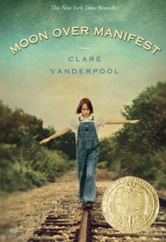 Young girl with shoulder length hair is balancing on a railroad track with her arms out to her side.