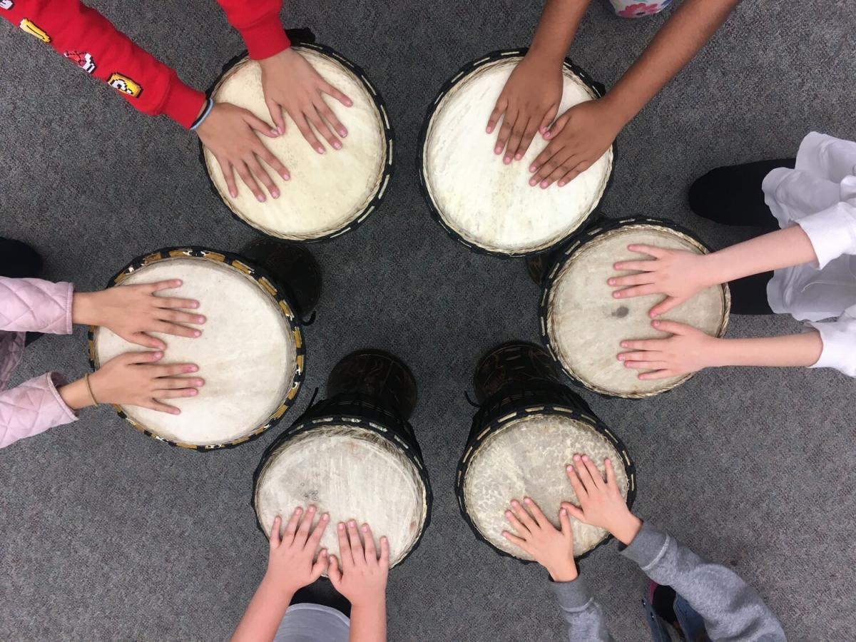 child hands playing drums