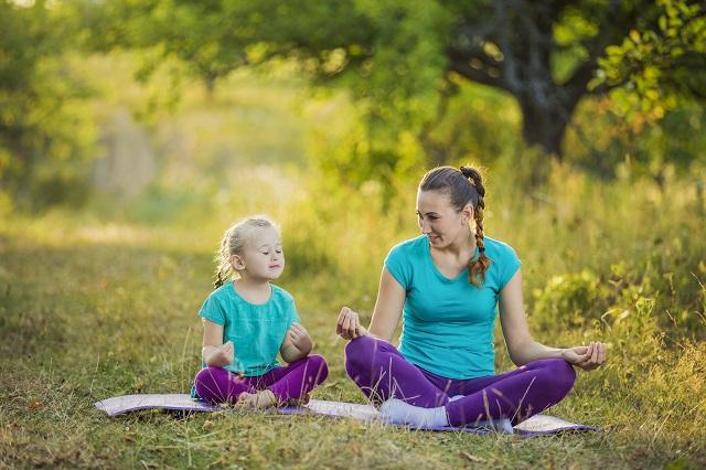 Adult and child meditating 